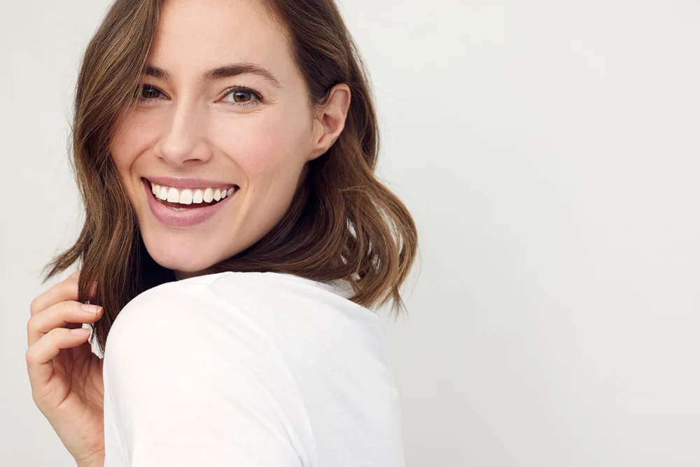 A smiling patient looking over their shoulder